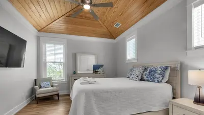 a bedroom with a bed with a ceiling fan at Seagrove Serenity in Santa Rosa Beach