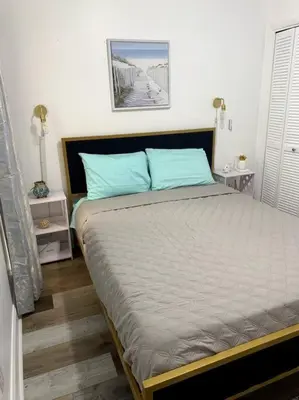 a bedroom with a large bed with blue pillows at FullyRenovated 1 min walk2 beach.5min to peir park in Panama City Beach