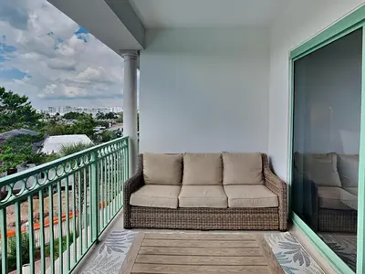 a couch sitting on a balcony with a view at Inn At Seacrest 303 - Seaside Sunrise in Rosemary Beach