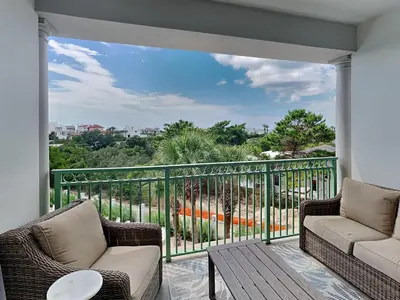a porch with two chairs and a balcony with a view at Inn At Seacrest 303 - Seaside Sunrise in Rosemary Beach