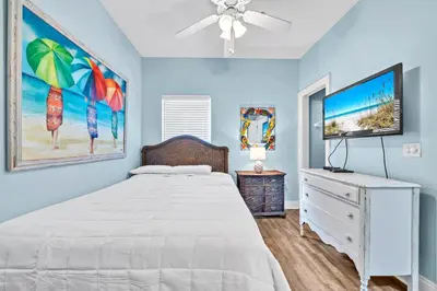 a bedroom with a bed and a flat screen tv at Summer Towne Cottages #8 - Sea-Questered in Panama City Beach