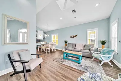 a living room with a couch and a table at Summer Towne Cottages #8 - Sea-Questered in Panama City Beach
