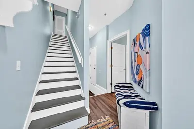 a staircase in a house with blue walls at Summer Towne Cottages #8 - Sea-Questered in Panama City Beach
