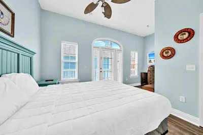 a large white bedroom with a large white bed at Summer Towne Cottages #8 - Sea-Questered in Panama City Beach