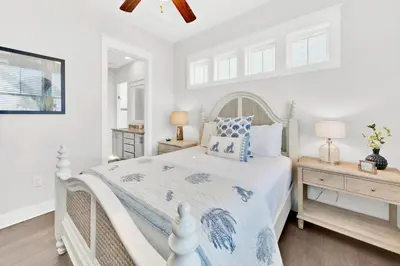 a white bedroom with a bed and two night stands at Town of Prominence 80C- The Wright Place in Santa Rosa Beach