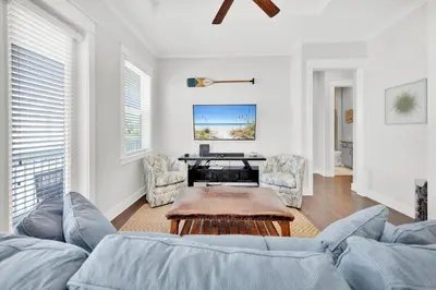 a living room with a couch and a table at Town of Prominence 80C- The Wright Place in Santa Rosa Beach