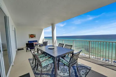 a balcony with a table and chairs and the ocean at Ocean Ritz 1203 in Panama City Beach