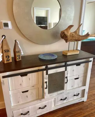 a console table with drawers and a mirror at Ocean Ritz 1203 in Panama City Beach