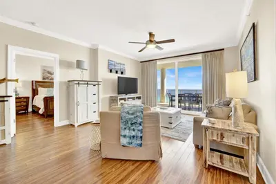 a living room with a couch and a tv at Ocean Ritz 1203 in Panama City Beach