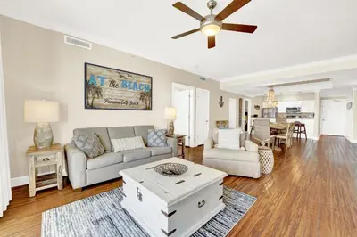 a living room with a couch and a ceiling fan at Ocean Ritz 1203 in Panama City Beach
