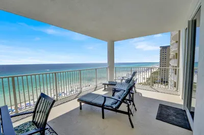 a balcony with chairs and a view of the ocean at Ocean Ritz 1203 in Panama City Beach