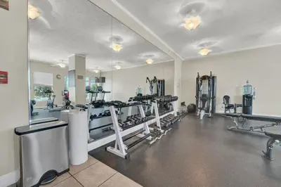 a gym with several treadmills and machines at Gulfcrest 206 in Panama City Beach