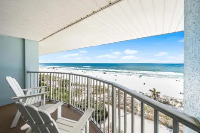 a balcony with two chairs and a view of the beach at Boardwalk Beach Hotel in Panama City Beach