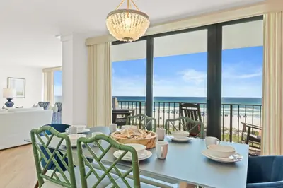 a dining room with a view of the ocean at Edgewater Beach Resort #207 Tower 2 by Book That Condo in Panama City Beach
