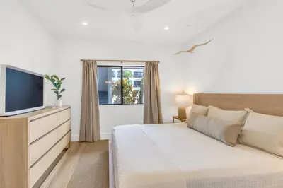 a bedroom with a bed and a tv and a window at Psalms in Santa Rosa Beach