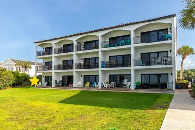 a large white building with a lawn in front of it at Psalms in Santa Rosa Beach