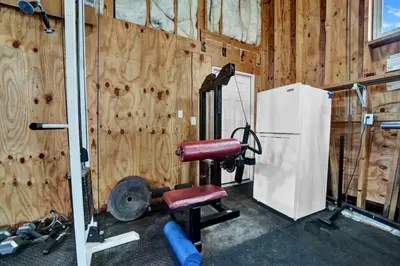 a gym with a chair and a refrigerator at Adorable 1 BDR with Full Kitchen Deck Washer Dryer in Panama City