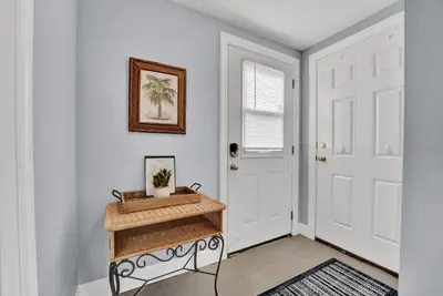 a hallway with a white door and a bench at Adorable 1 BDR with Full Kitchen Deck Washer Dryer in Panama City