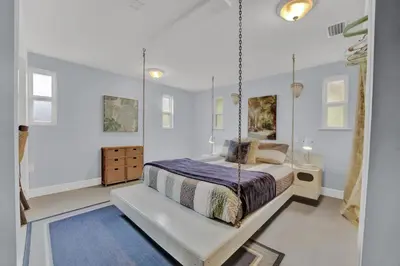 a bedroom with a swinging bed with a blue rug at Adorable 1 BDR with Full Kitchen Deck Washer Dryer in Panama City