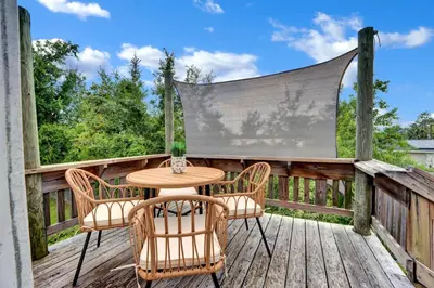 a patio with a table and chairs on a deck at Adorable 1 BDR with Full Kitchen Deck Washer Dryer in Panama City