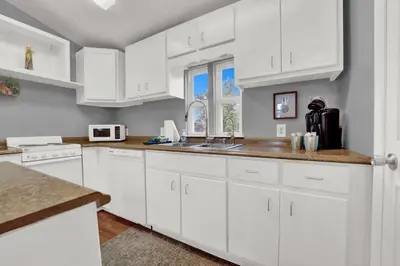 a white kitchen with white cabinets and a sink at Adorable 1 BDR with Full Kitchen Deck Washer Dryer in Panama City