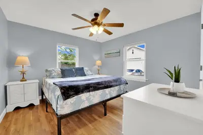 a bedroom with a bed and a ceiling fan at Luxury Bathroom Home with Game Room 25 Mins to PCB in Panama City