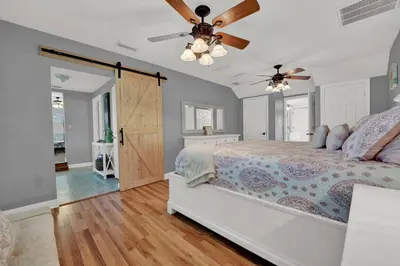 a bedroom with a bed and a ceiling fan at Luxury Bathroom Home with Game Room 25 Mins to PCB in Panama City