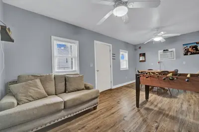 a living room with a couch and a ping pong table at Loaded House and Guest House w Game Room Gym in Panama City