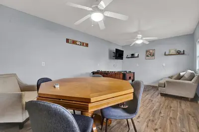 a living room with a wooden table and chairs at Loaded House and Guest House w Game Room Gym in Panama City