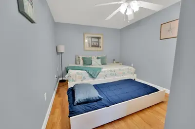 a bedroom with a bed and a ceiling fan at Loaded House and Guest House w Game Room Gym in Panama City