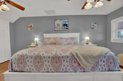 a bedroom with a large bed with two night stands at Loaded House and Guest House w Game Room Gym in Panama City