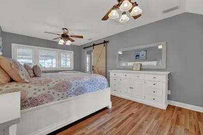 a bedroom with a bed and a ceiling fan at Loaded House and Guest House w Game Room Gym in Panama City