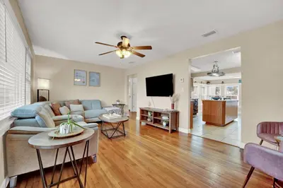 a living room with a couch and a ceiling fan at Loaded House and Guest House w Game Room Gym in Panama City