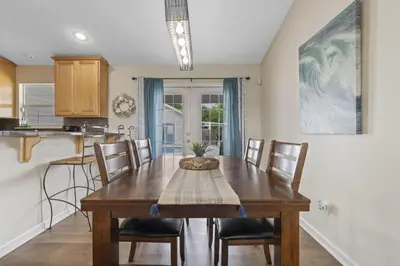 a kitchen and dining room with a wooden table and chairs at Escape to Paradise w Saltwater Pool 25 Min to PCB in Panama City