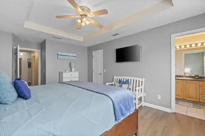 a bedroom with a bed and a ceiling fan at Escape to Paradise w Saltwater Pool 25 Min to PCB in Panama City