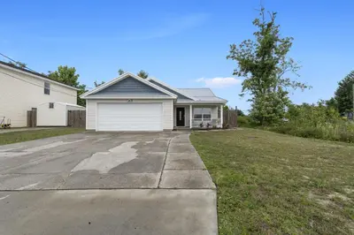 a house with a driveway and a garage at Escape to Paradise w Saltwater Pool 25 Min to PCB in Panama City