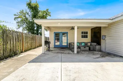 a house with a blue door and a fence at Escape to Paradise w Saltwater Pool 25 Min to PCB in Panama City