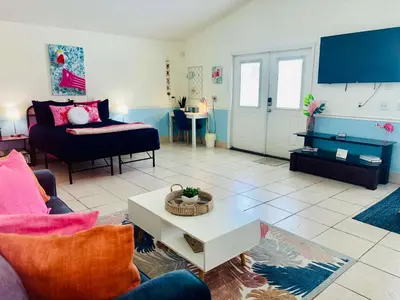 a living room with a couch and a table at Luxe Pool Casita w Saltwater Pool 25 Min to PCB in Panama City