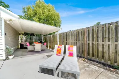 a white bench in a backyard with a fence at Luxe Pool Casita w Saltwater Pool 25 Min to PCB in Panama City