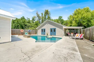 a backyard with a swimming pool and a fence at Luxe Pool Casita w Saltwater Pool 25 Min to PCB in Panama City