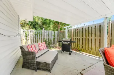 a covered patio with a couch and a grill at Luxe Pool Casita w Saltwater Pool 25 Min to PCB in Panama City