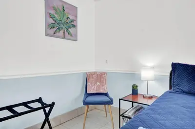 a bedroom with a bed and a chair and a table at Luxe Pool Casita w Saltwater Pool 25 Min to PCB in Panama City