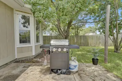a barbecue grill sitting outside of a house at Modern Getaway North of Panama City Beach in Panama City
