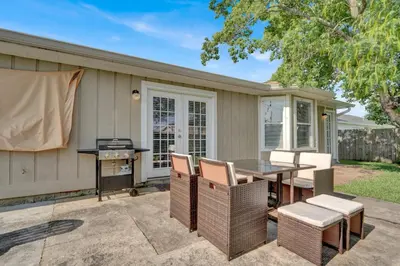 a patio with a table and chairs and a grill at Modern Getaway North of Panama City Beach in Panama City