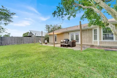 a backyard of a house with a fence at Modern Getaway North of Panama City Beach in Panama City