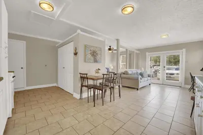 a dining room and living room with a table and chairs at Luxe Guest Suite Near The Emerald Coast of PCB in Panama City