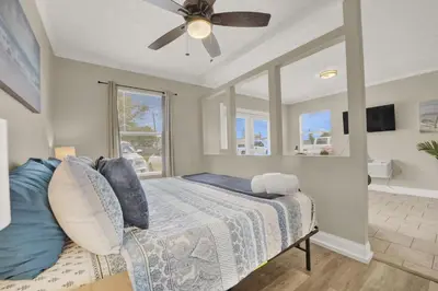 a bedroom with a bed and a ceiling fan at Luxe Guest Suite Near The Emerald Coast of PCB in Panama City