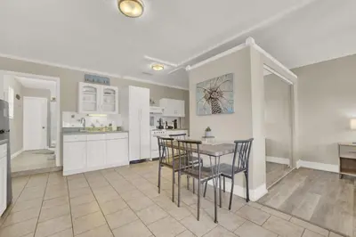 a kitchen with a table and chairs in a room at Luxe Guest Suite Near The Emerald Coast of PCB in Panama City