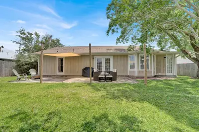 a house with a patio and a fence at Luxe Guest Suite Near The Emerald Coast of PCB in Panama City