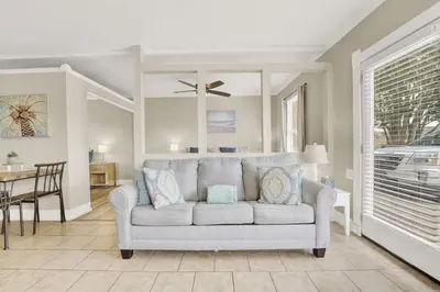 a living room with a couch and a dining room at Luxe Guest Suite Near The Emerald Coast of PCB in Panama City